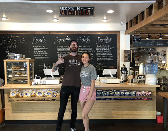 Employees in front of our menu